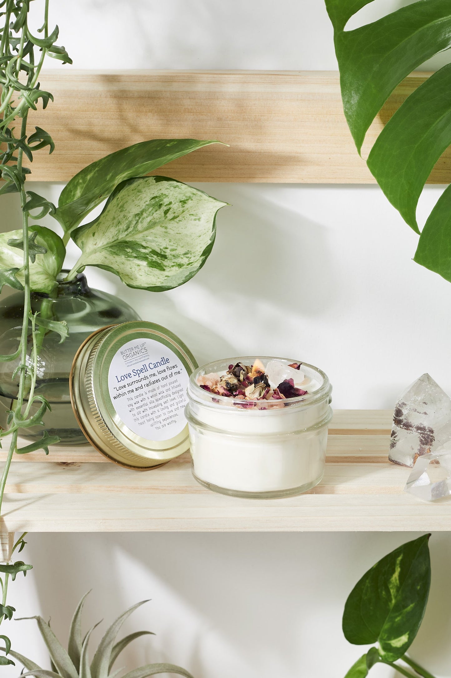 love spell intention candle is 4 oz of hand-poured soy wax in a glass jar with a metal lid open on shelf