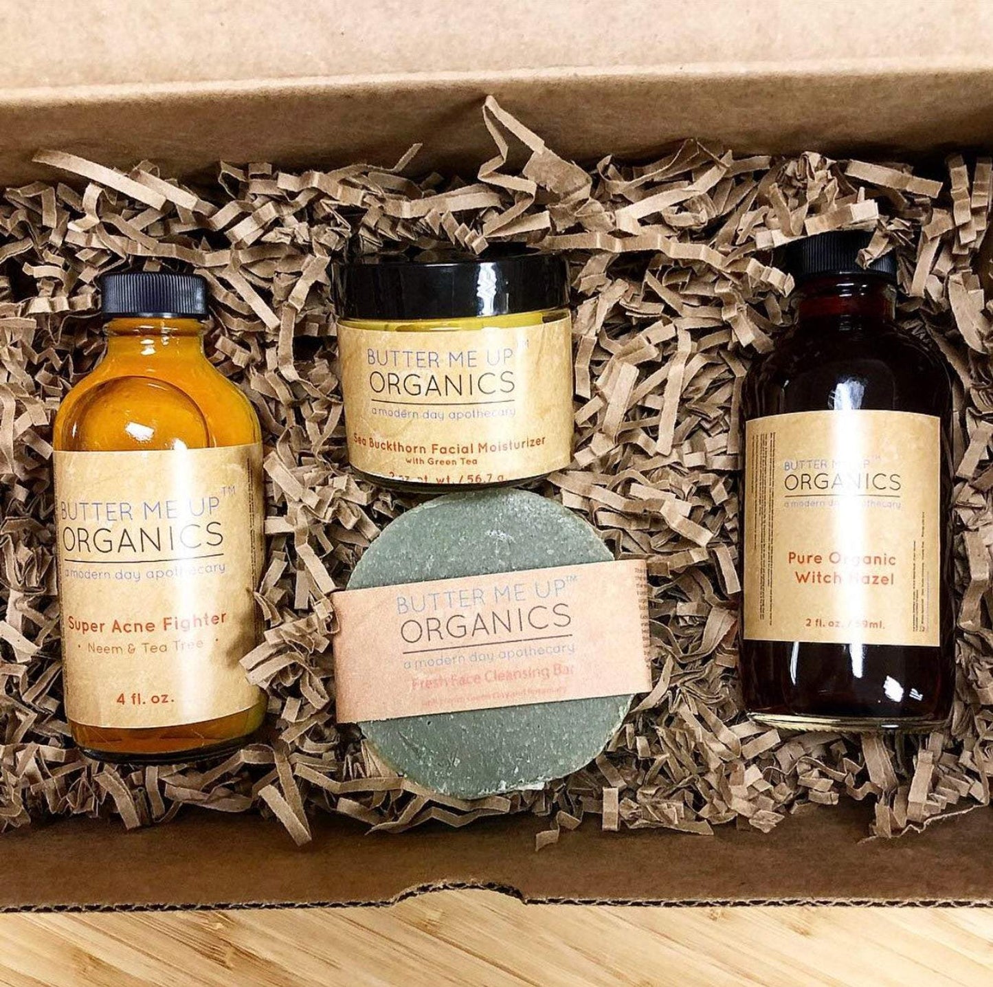 Organic Acne Bundle includes super acne fighter 4 fl oz, sea buckthorn facial moisturizer with green tea 56.7 g, fresh face cleansing bar, and pure organic witch hazel 2 fl oz, all butter me up organic brand a modern day apothecary
